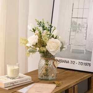 Artificial white roses in a textured glass vase with a heart tag for home decor