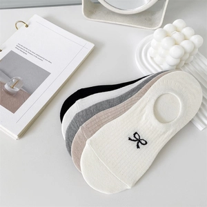 Detail of five pairs of low-cut invisible socks with bow embroidery and ribbed texture