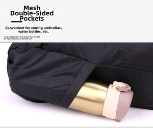 Detail shot of the black backpack's side mesh pocket holding a pink water bottle