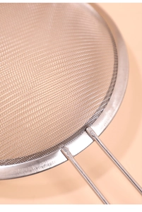 Close-up of fine stainless steel mesh and sturdy welded handle for juice filtering