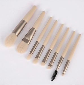Detail of 8pcs travel makeup brush set with beige handles and champagne gold ferrules
