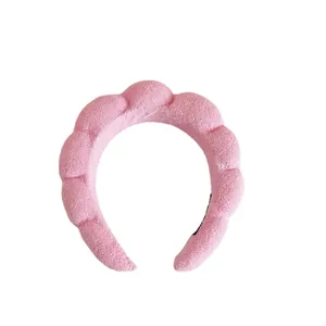 Close-up of pink padded braided headband in soft absorbent terry cloth fabric