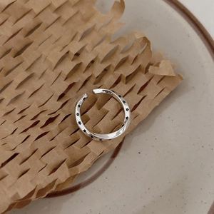 925 silver Mobius ring with black star patterns on a textured ceramic surface