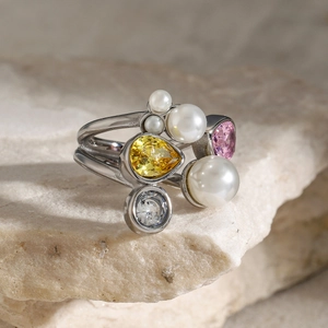 Detailed macro view of an irregular 18k gold open ring with pearls and colorful zircons