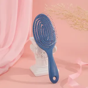 Detail of blue vented hair brush showing flexible spiral design and massage bristles
