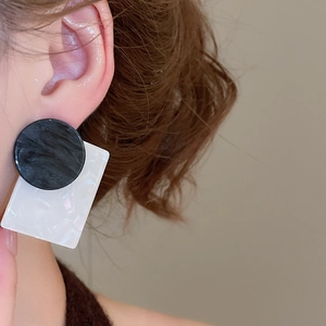 Close-up detail of geometric square shell wood bead earrings with marble texture on model