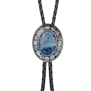 Detail of western bolo tie with blue agate stone inlay and black braided leather cord