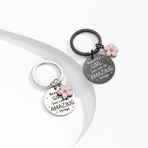 Portachiavi in acciaio inox argento e nero con frase motivazionale e ciondolo fiore