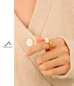 Detail of a vintage 18K gold plated stainless steel ring with a white seashell inlay
