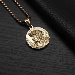 Detailed macro of gold embossed Jesus Ecce Homo medallion pendant with steel chain