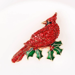 Elegant cardinal bird brooch with red rhinestones and green holly leaves on gold metal