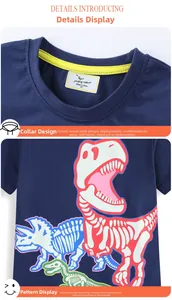 Detail of boys' navy blue T-shirt featuring a crew neck and luminous dinosaur prints