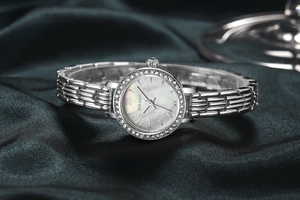 Detail of silver ladies watch featuring a mother of pearl dial and crystal bezel