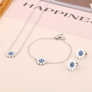 Detail of daisy jewelry set with blue evil eye centers including necklace and earrings