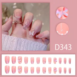 Detail of pink gradient press-on nails with 3D butterfly, pearls and 24-piece full set