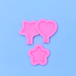 Pink heart and star silicone molds for DIY crafts on a light blue background