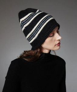 Close-up of soft black wool knit beanie with white, gray, and blue striped patterns