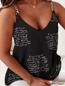 Detail of deep V-neckline on black tank top with white script print and gold chain straps