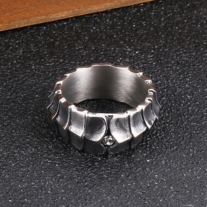 Detailed view of silver stainless steel ring with gear texture and inlaid diamond
