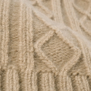Thick merino wool knit beanie in khaki featuring a warm cable and diamond stitch pattern