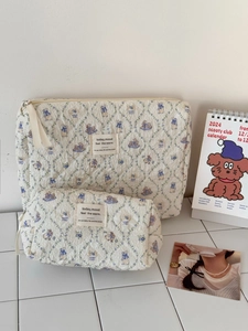 Detail of floral rabbit quilted makeup bag set with a large pouch and cylinder case