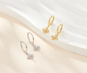 Detailed macro shot of S925 sterling silver four-leaf clover earrings with zircon