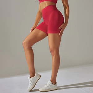 Close-up of red seamless high-waist yoga shorts showing peach lift effect and knit texture