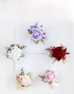 Macro shot of artificial rose boutonniere set in five elegant colors for weddings