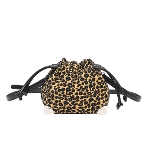 Detail of leopard print bucket bag with silver metal corner protectors and drawstring