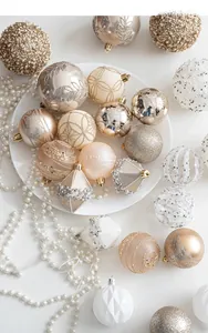 Detailed view of champagne gold Christmas balls with embossed patterns and pearls