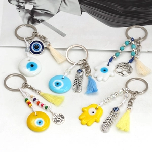 Detailed view of evil eye keychains with Hamsa hand and colorful resin charms