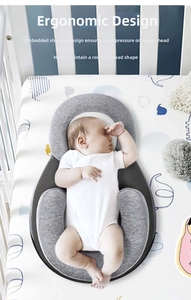 Macro detail of ergonomic baby sleep positioner with U-shaped design for flat head prevention