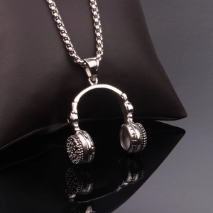 Detail view of silver headphone pendant necklace with box chain on professional display
