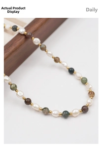Close-up of handmade necklace with colorful natural stones, freshwater pearls, and gold beads