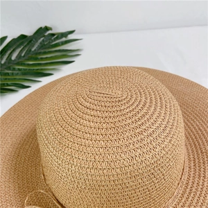 Close-up of high-density woven texture on a beige wide-brim straw hat crown