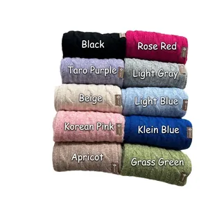 Chunky knit wool scarf in multiple candy colors with decorative leather labels for warmth
