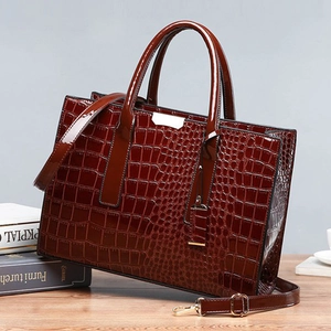 Elegant deep red crocodile pattern handbag with top handles and gold metal accents
