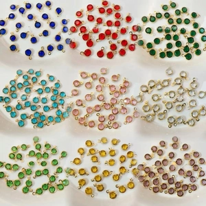 Macro shot of colorful glass pendants in nine hues with gold-plated copper frames