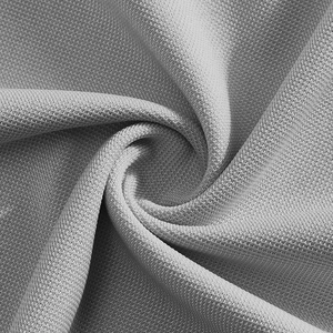 Close-up of gray breathable knitted mesh fabric texture on men's polo shirt