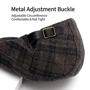 Plaid wool ivy cap featuring an adjustable black leather strap and gold metal buckle