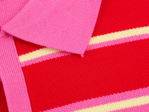 Macro detail of vibrant knit polo collar with colorful pink and yellow stripes