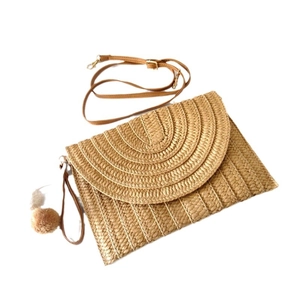 Handcrafted paper braid crossbody bag with brown PU straps and decorative pom pom charm