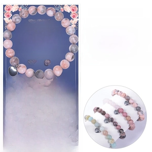 Detail view of 8mm pink zebra stone bracelet with heart pendant and gift card for mom