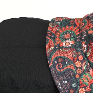 Detail of reversible bucket hat showing paisley pattern and black twill fabric stitching