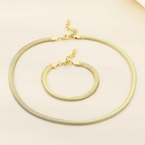 Detailed view of 18k gold plated flat snake chain necklace and bracelet set with lobster clasp