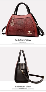 Detail of crocodile embossed texture and dual zipper compartments on red crossbody bag