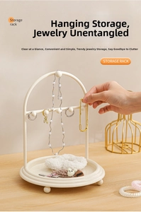 Detail view of arched jewelry stand featuring a necklace hook and round storage tray