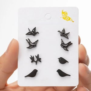 Detail of four pairs of black stainless steel bird and origami crane stud earring set