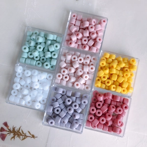 Colorful cylindrical acrylic beads for DIY jewelry making in a transparent storage box