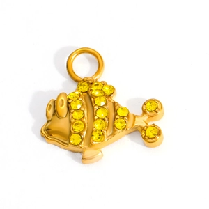 Detailed macro view of 18k gold plated fish pendant with sparkling yellow crystals